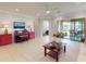 Spacious living room with tile flooring, a ceiling fan, and access to the outdoor patio at 2436 Arugula Dr, North Port, FL 34289