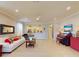 Open-concept living room featuring tile floors and neutral colors, creating a relaxing atmosphere at 2436 Arugula Dr, North Port, FL 34289