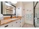 Bathroom featuring vanity with decorative countertop and a glass-enclosed shower at 26169 Explorer Rd # 7P, Punta Gorda, FL 33983