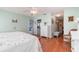 Spacious bedroom with hardwood floors, light-green walls, and white furniture at 26169 Explorer Rd # 7P, Punta Gorda, FL 33983