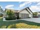 Charming home featuring a well-manicured lawn, mature landscaping, and a spacious two-car garage at 26169 Explorer Rd # 7P, Punta Gorda, FL 33983