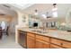 Open kitchen design with stainless steel dishwasher and a breakfast bar overlooking the living area at 26169 Explorer Rd # 7P, Punta Gorda, FL 33983