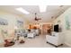 Bright open-concept living room with vaulted ceilings, tile floors, and seamless kitchen access at 26169 Explorer Rd # 7P, Punta Gorda, FL 33983