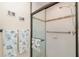 Close-up of the tiled shower featuring updated fixtures and a glass door at 26169 Explorer Rd # 7P, Punta Gorda, FL 33983