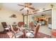 Bright sun room with glass table and wicker chairs leading to a cozy living space at 26169 Explorer Rd # 7P, Punta Gorda, FL 33983