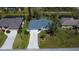 A beautifully landscaped single Gathering home boasts great curb appeal with a long drive and a well-manicured front lawn at 27250 Salta Dr, Punta Gorda, FL 33983