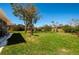 Backyard featuring green grass, landscaping, and fencing at 27250 Salta Dr, Punta Gorda, FL 33983