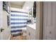 Bathroom featuring a striped shower curtain, modern vanity, and neutral color palette at 27250 Salta Dr, Punta Gorda, FL 33983