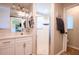 Bathroom featuring a modern vanity with white cabinets and a sliding glass shower door at 27250 Salta Dr, Punta Gorda, FL 33983