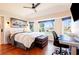 Bedroom featuring wood floors, bay windows, a ceiling fan, and natural light at 27250 Salta Dr, Punta Gorda, FL 33983