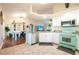 Spacious eat-in kitchen featuring white cabinets, stainless steel appliances, and unique vintage style refrigerator at 27250 Salta Dr, Punta Gorda, FL 33983