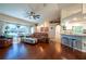 Inviting living room with hardwood floors, a leather sofa, and an open layout flowing into the kitchen at 27250 Salta Dr, Punta Gorda, FL 33983