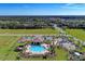 Aerial view shows a community pool, playground, and surrounding homes, showcasing the layout of the neighborhood at 2810 Sherman Oak Dr, North Port, FL 34289