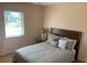 Comfortable bedroom with a queen bed, ample natural light, and a calming, neutral color scheme at 293 Broadmoor Ln, Rotonda West, FL 33947