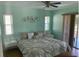 Serene bedroom with a ceiling fan, ample natural light, and sliding glass doors at 293 Broadmoor Ln, Rotonda West, FL 33947