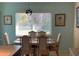 Inviting dining area with a traditional table set, soft lighting, and serene window views at 293 Broadmoor Ln, Rotonda West, FL 33947