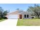 Charming single-story home with a two-car garage and a well-manicured lawn at 3471 Ledgewood St, Port Charlotte, FL 33948