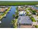 Gorgeous waterfront home featuring a private dock, screened-in pool, and lush tropical landscaping at 3812 Carupano Ct, Punta Gorda, FL 33950