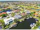Aerial view showcasing the waterfront home's private dock, lush landscaping, and serene canal setting at 3812 Carupano Ct, Punta Gorda, FL 33950