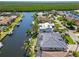 Gorgeous waterfront home featuring a private dock, screened-in pool, and lush tropical landscaping at 3812 Carupano Ct, Punta Gorda, FL 33950