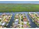 Captivating aerial view of a waterfront home nestled among lush canals and a vibrant community, close to nature reserves at 3812 Carupano Ct, Punta Gorda, FL 33950