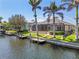 A view of the back of the home featuring a screened-in pool and dock at 3812 Carupano Ct, Punta Gorda, FL 33950