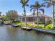 A view of the back of the home featuring a screened-in pool and dock at 3812 Carupano Ct, Punta Gorda, FL 33950