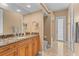 This bathroom has granite countertops, wood cabinets, and a large mirror, complemented by tile flooring at 3812 Carupano Ct, Punta Gorda, FL 33950