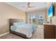 Comfortable bedroom with a patio door, ceiling fan and a dresser, inviting plenty of natural light at 3812 Carupano Ct, Punta Gorda, FL 33950