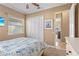 Well-lit bedroom featuring a ceiling fan, double closets, and a bed with blue patterned bedding at 3812 Carupano Ct, Punta Gorda, FL 33950