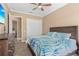 Charming bedroom with a ceiling fan, dresser, and a serene view to another room, radiating warmth at 3812 Carupano Ct, Punta Gorda, FL 33950