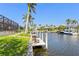 A private dock with chairs sits along the waterfront canal in a tropical paradise at 3812 Carupano Ct, Punta Gorda, FL 33950