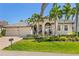 Charming single-story home with a well-manicured lawn, mature palms, and a paved driveway at 3812 Carupano Ct, Punta Gorda, FL 33950