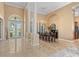 Grand foyer with soaring ceilings, marble floors, and elegant dining area with natural light at 3812 Carupano Ct, Punta Gorda, FL 33950