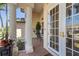 Covered front porch with brick pavers and decorative columns leads to a glass front door at 3812 Carupano Ct, Punta Gorda, FL 33950