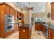 Spacious kitchen with wooden cabinetry, stainless steel appliances, and large island counter at 3812 Carupano Ct, Punta Gorda, FL 33950