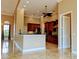 An open-concept kitchen featuring wooden cabinetry, granite countertops, and stainless steel appliances at 3812 Carupano Ct, Punta Gorda, FL 33950