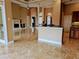 A spacious living room with stone fireplace, tile floors, and a breakfast bar leading to the kitchen at 3812 Carupano Ct, Punta Gorda, FL 33950
