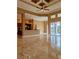Open-concept living area with tile floors, a breakfast bar, and sliding glass doors to the patio at 3812 Carupano Ct, Punta Gorda, FL 33950