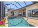 Enclosed pool and patio area boasts an outdoor TV, ceiling fan, and a relaxing space for entertainment at 3812 Carupano Ct, Punta Gorda, FL 33950