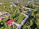 Aerial view of homes situated among dense trees with nearby roads and neighborhoods at 4221 Circleville St, North Port, FL 34286