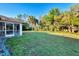 Expansive backyard featuring lush green grass and mature trees offering privacy and space at 4221 Circleville St, North Port, FL 34286