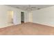 Bedroom with neutral carpet and ceiling fan, featuring access to the bathroom and closet at 4221 Circleville St, North Port, FL 34286