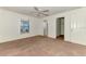 A carpeted bedroom with a ceiling fan, closet, and ensuite bathroom at 4221 Circleville St, North Port, FL 34286