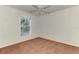 A carpeted bedroom featuring a ceiling fan and a bright window view at 4221 Circleville St, North Port, FL 34286