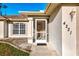 Home exterior featuring a screened entrance and manicured landscaping at 4221 Circleville St, North Port, FL 34286