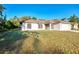 Charming single-story home with a well-maintained lawn, an attached two-car garage, and freshly painted white exterior at 4221 Circleville St, North Port, FL 34286