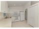 Bright kitchen featuring white cabinets, tile flooring, and modern appliances at 4221 Circleville St, North Port, FL 34286