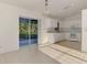 Eat in kitchen with white cabinets, appliances, and sliding glass doors to the patio at 4221 Circleville St, North Port, FL 34286