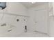 Bright laundry room featuring a utility sink, shelving, and a door leading outside at 4221 Circleville St, North Port, FL 34286